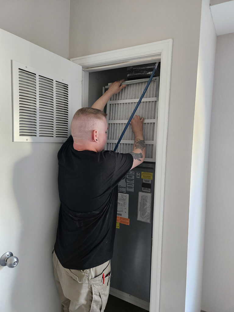 Staff members changed an air filter for one of the rooms in the senior living community.